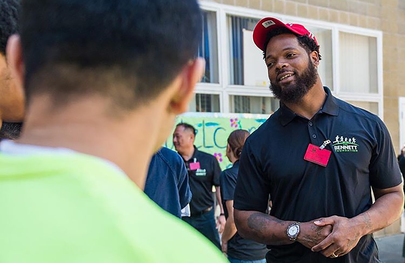 Seahawk Michael Bennett interacting with youth at the inauguration of the Bennett Foundation Garden