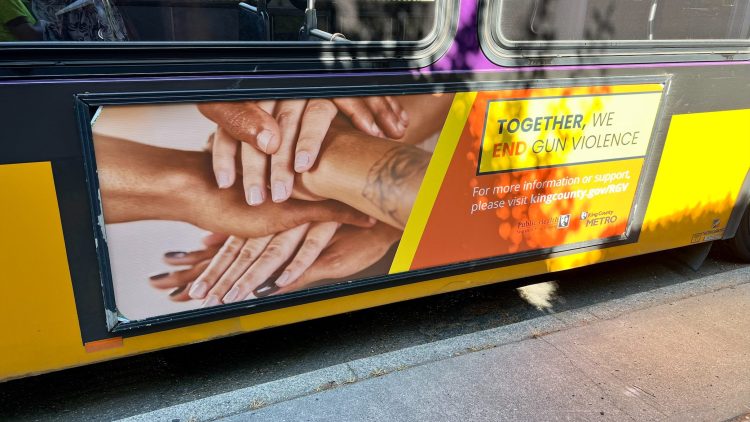 Image of a King County Metro bus with an advertisement for King County's Together We End Gun Violence campaign.