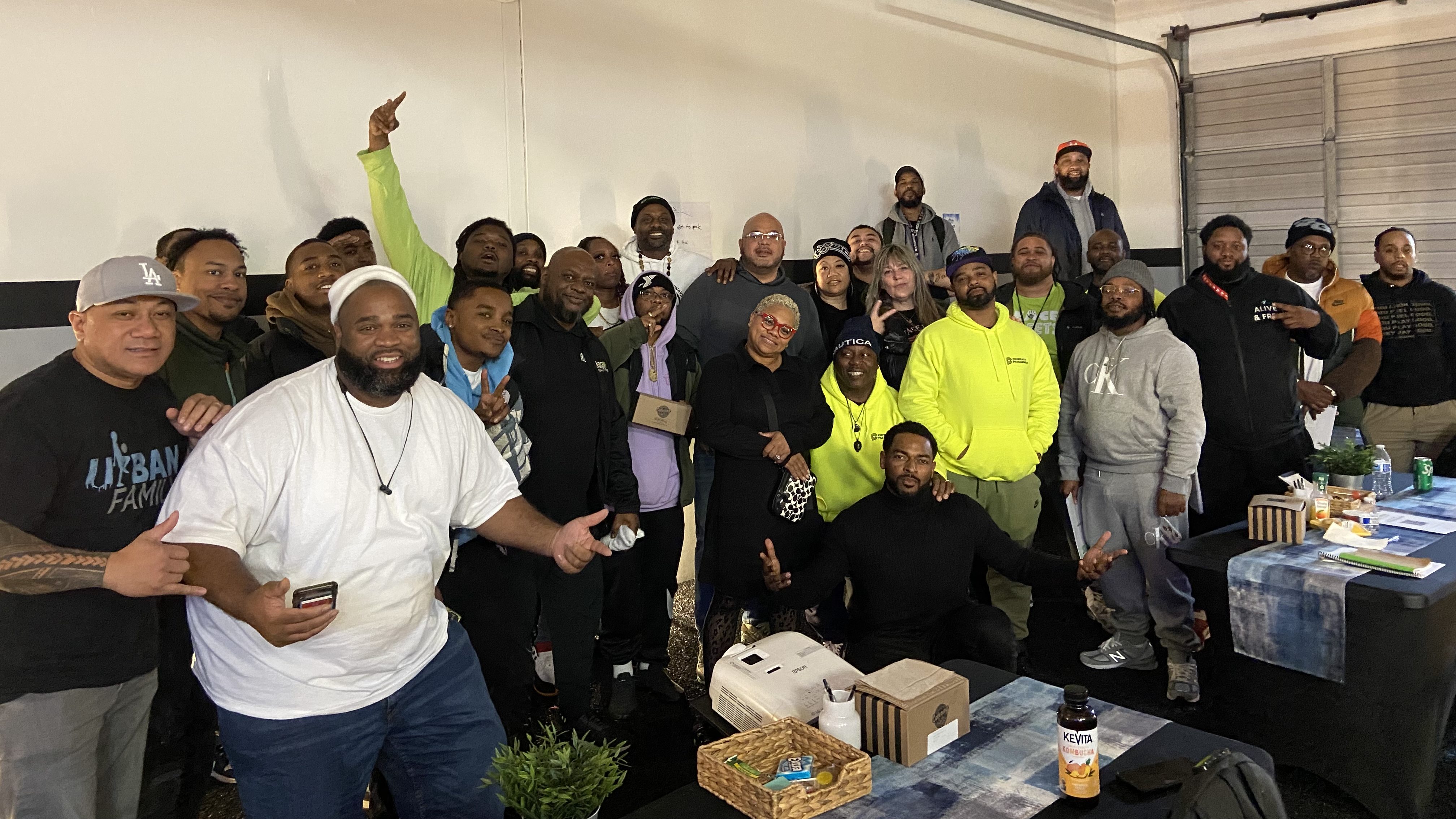 Group of 29 people gathered around each other and posing for a picture. 